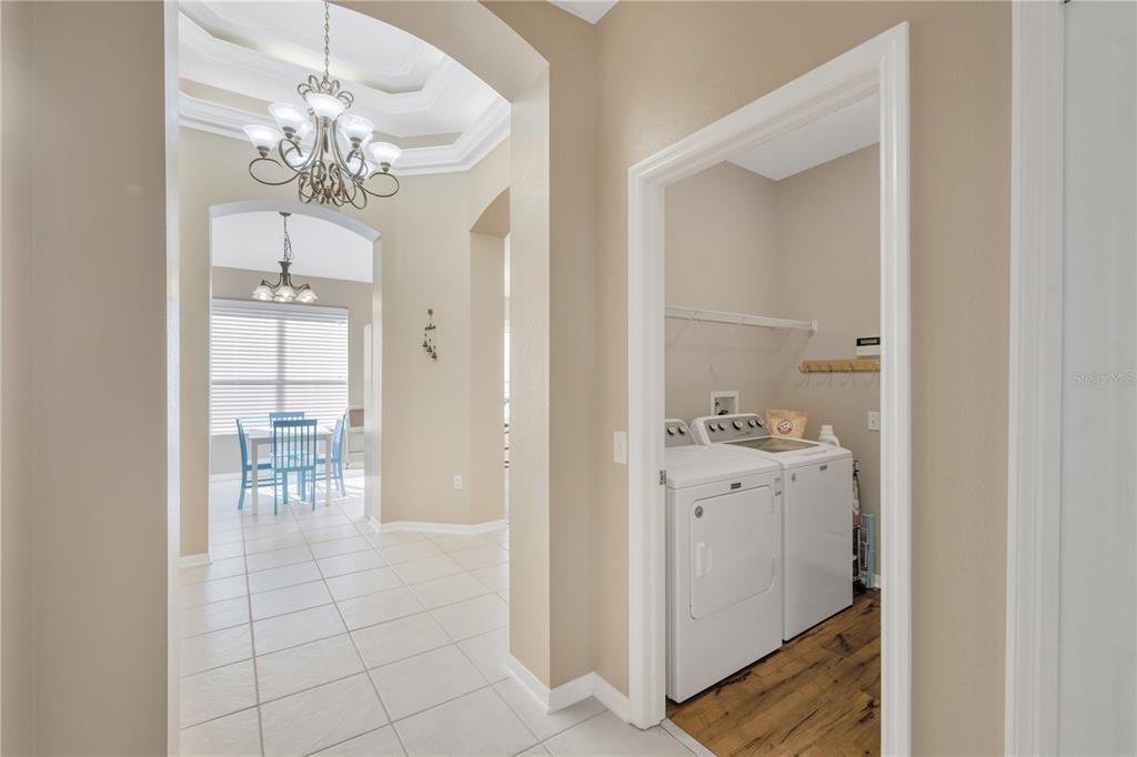 17115 Falconridge Road Lithia, FL 33547 - Photo 22 of 33 a view of a hallway with dining area chandelier and hallway