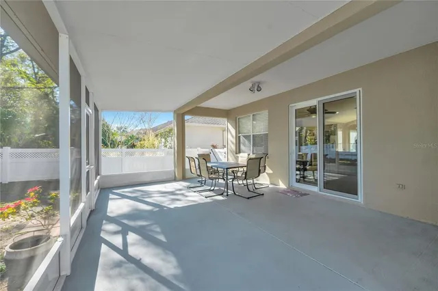 a view of a two room with furniture and floor to ceiling window