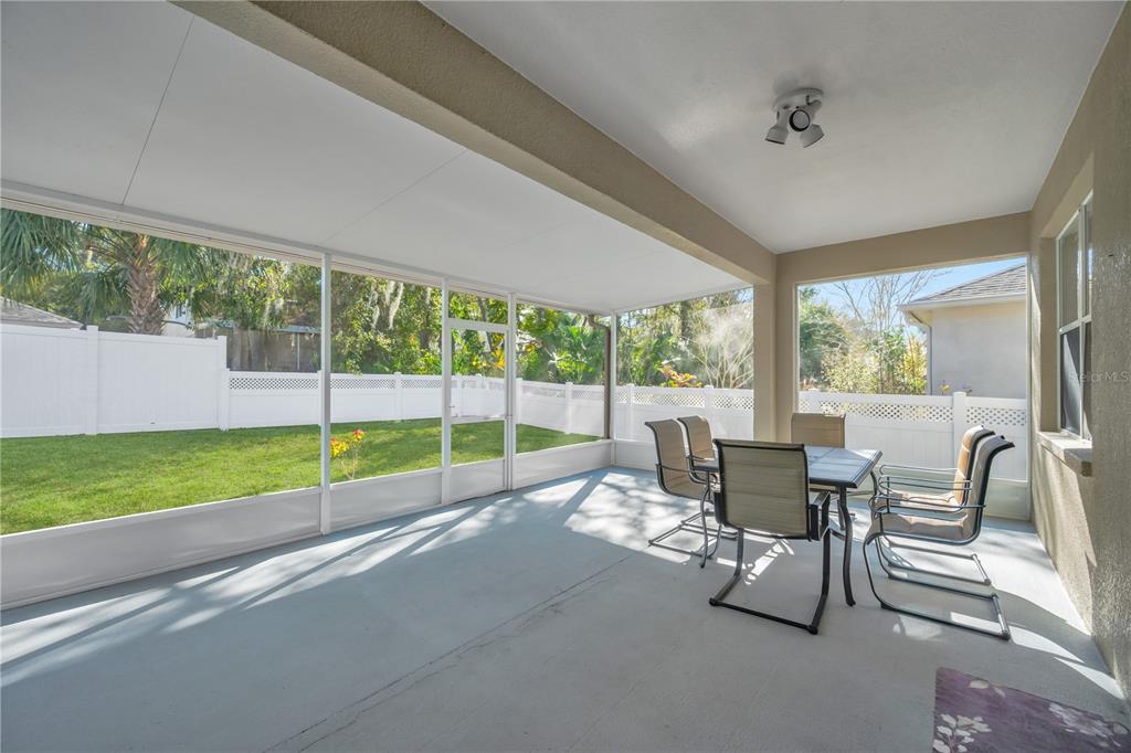 17115 Falconridge Road Lithia, FL 33547 - Photo 24 of 33 a view of a porch with chairs and backyard