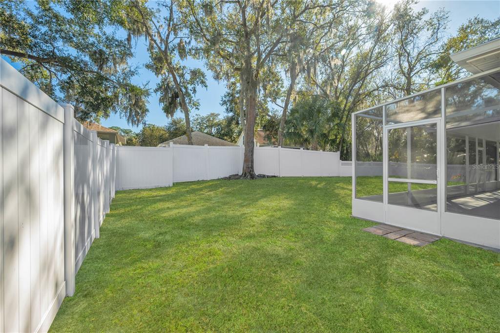 17115 Falconridge Road Lithia, FL 33547 - Photo 28 of 33 a view of a backyard with large trees