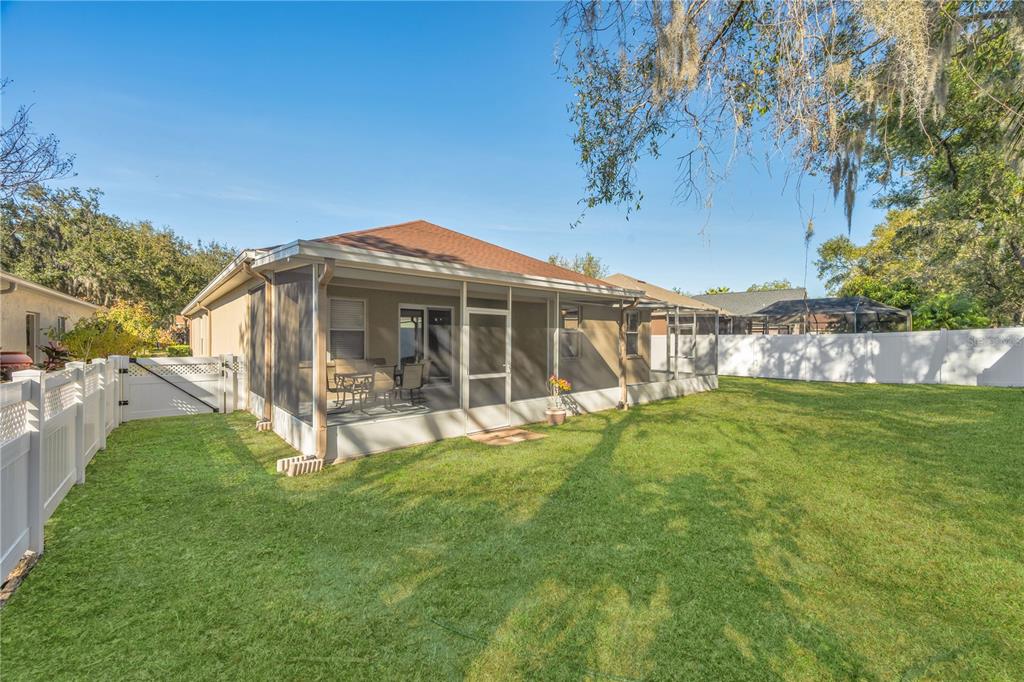 17115 Falconridge Road Lithia, FL 33547 - Photo 30 of 33 a view of an house with backyard porch and garden
