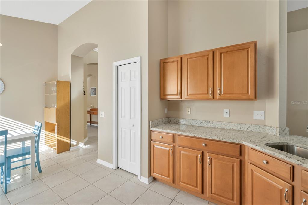 17115 Falconridge Road Lithia, FL 33547 - Photo 6 of 33 a kitchen with granite countertop white cabinets and stainless steel appliances