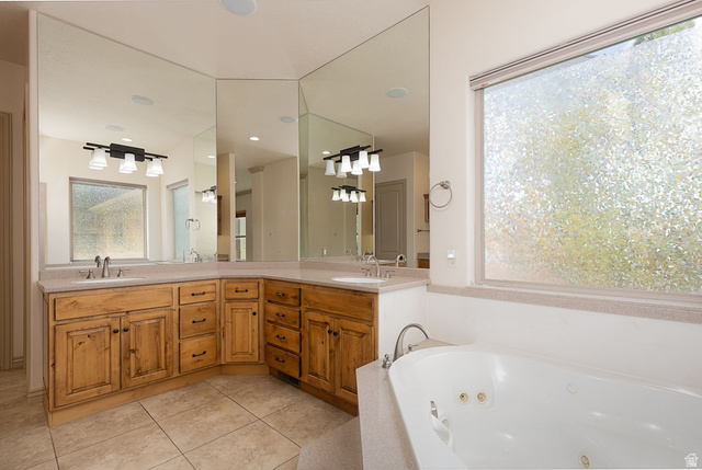 888 East Fiddlers Canyon Road Cedar City, UT 84721 - Photo 32 of 74 Full bathroom featuring double vanity, light tile patterned flooring, and a whirlpool tub
