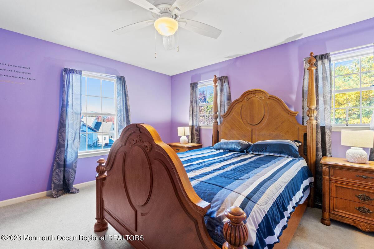 6 Forest View Drive Bayville, NJ 08721 - Photo 13 of 39 a bedroom with a bed a chandelier and dresser