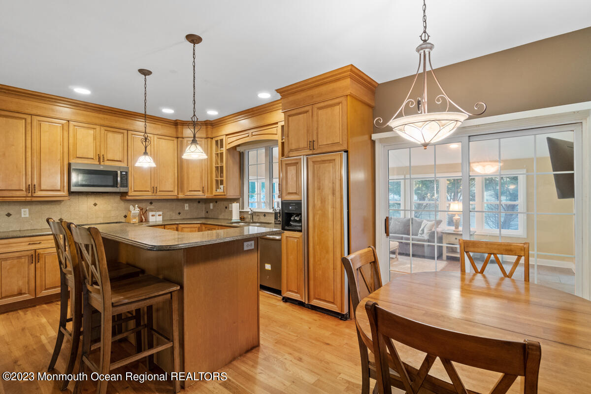 6 Forest View Drive Bayville, NJ 08721 - Photo 22 of 39 a kitchen with kitchen island a dining table chairs and a wooden floor