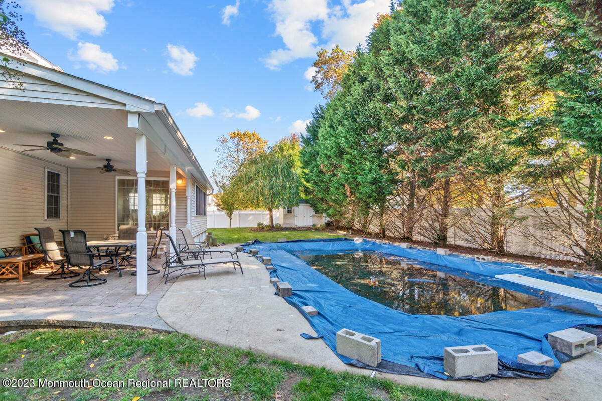 6 Forest View Drive Bayville, NJ 08721 - Photo 29 of 39 a swimming pool with outdoor seating and yard