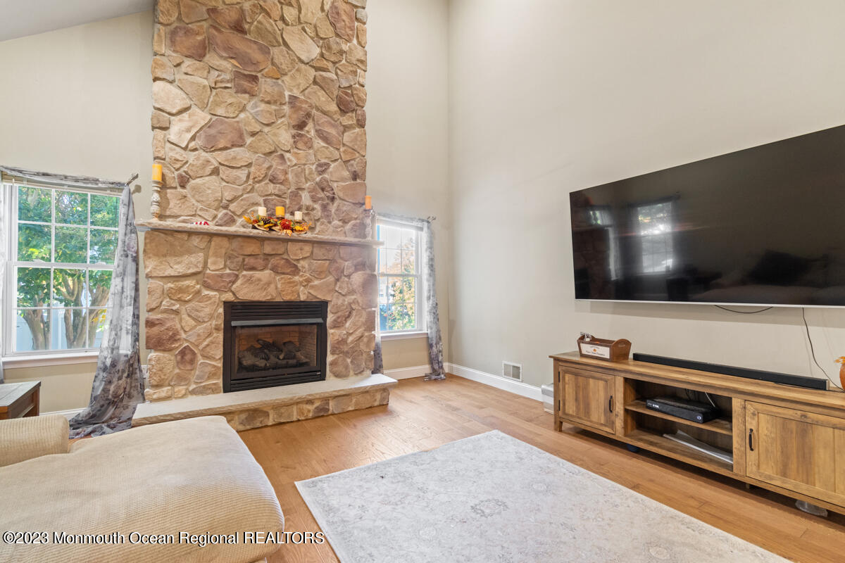 6 Forest View Drive Bayville, NJ 08721 - Photo 7 of 39 a living room with a flat screen tv and a fireplace