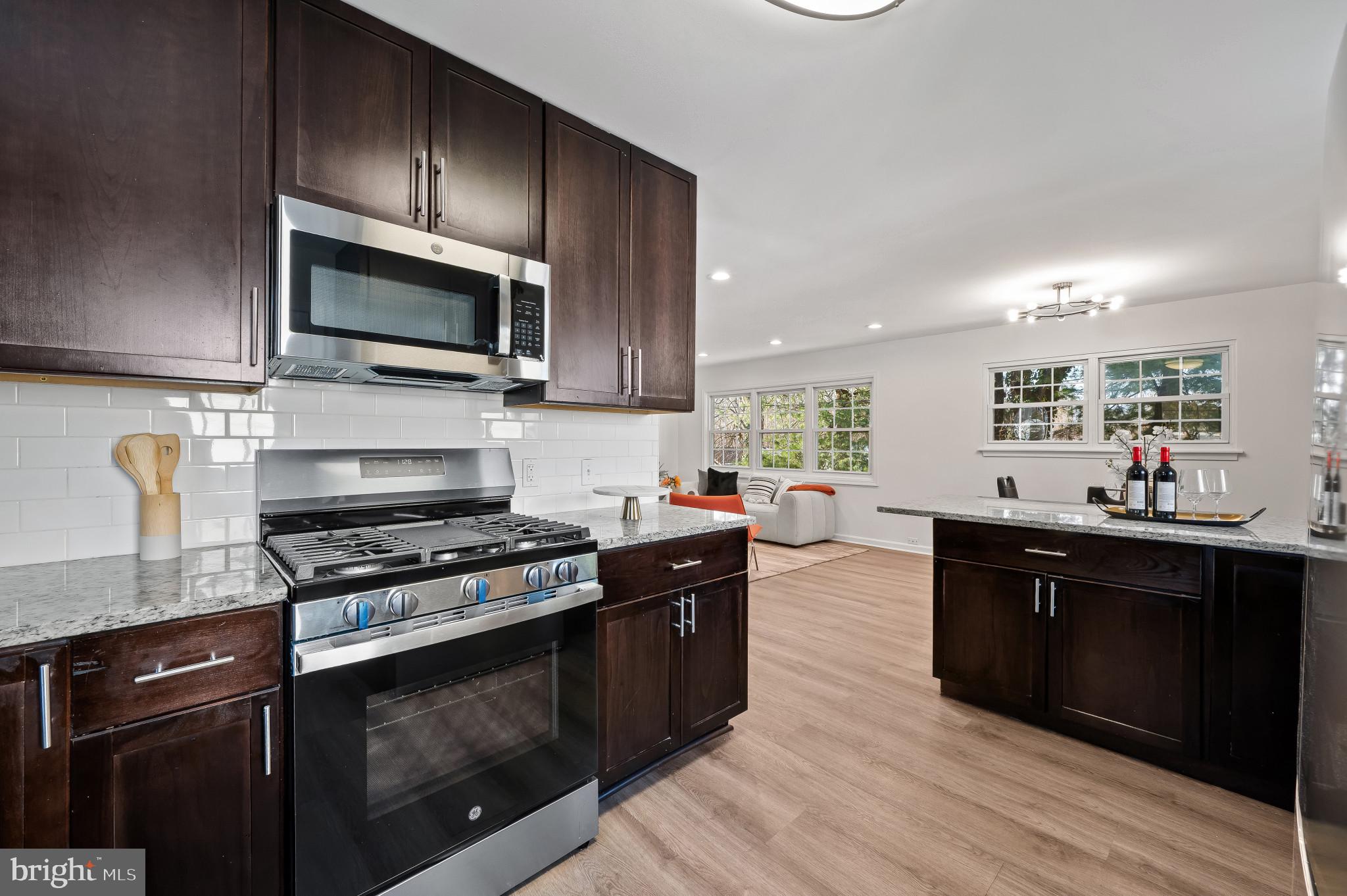 200 Timber Grove Road Reisterstown, MD 21136 - Photo 4 of 30 a kitchen with stainless steel appliances a stove microwave and cabinets