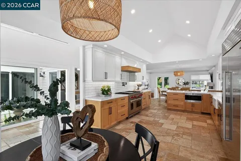 a large kitchen with a table and chairs