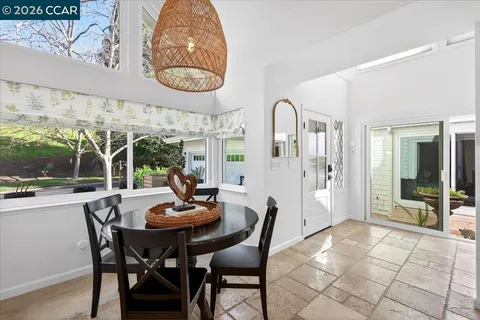 a view of a dining room with furniture window and outside view