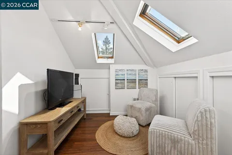 a bedroom with a bed and painting on the wall