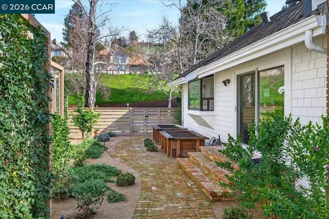 a front view of a house with backyard and sitting area