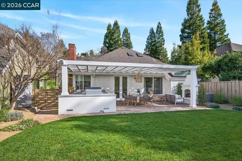 a view of a patio with a table chairs and a backyard