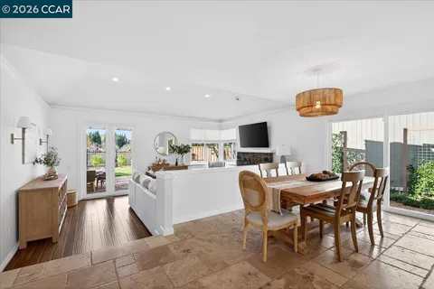 a view of a dining room with furniture and a flat screen tv