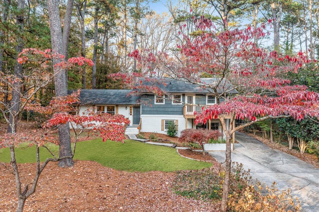 3860 Cardinal Drive Tucker, GA 30084 - Photo 1 of 1 a front view of a house with a yard and potted plants