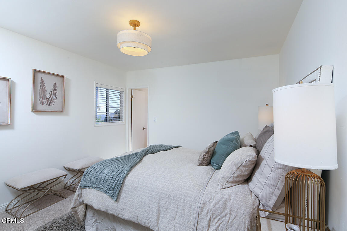 3330 Paraiso Way Glendale, CA 91214 - Photo 19 of 32 a bedroom with a bed and a lamp on table