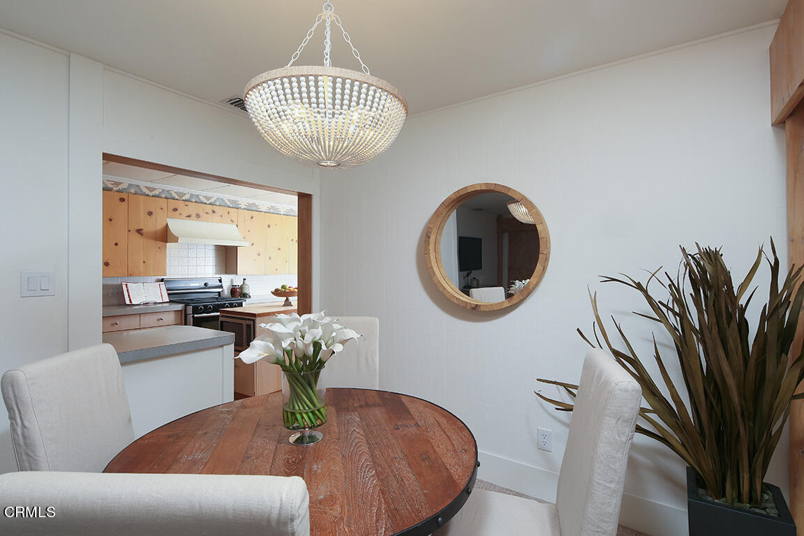 3330 Paraiso Way Glendale, CA 91214 - Photo 8 of 32 a living room with couches a dining table and a chandelier