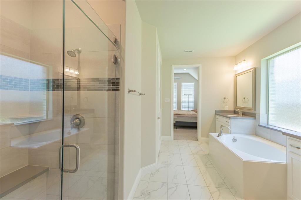 3920 Bentgrass Road Plano, TX 75023 - Photo 24 of 30 a bathroom with a tub shower and sink