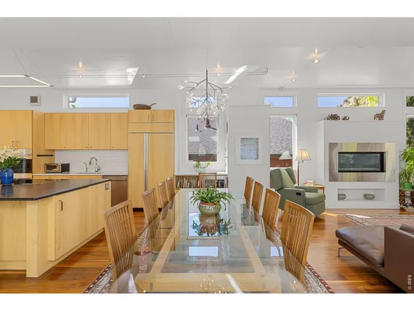 a view of a patio with table and chairs with wooden floor and a potted plants