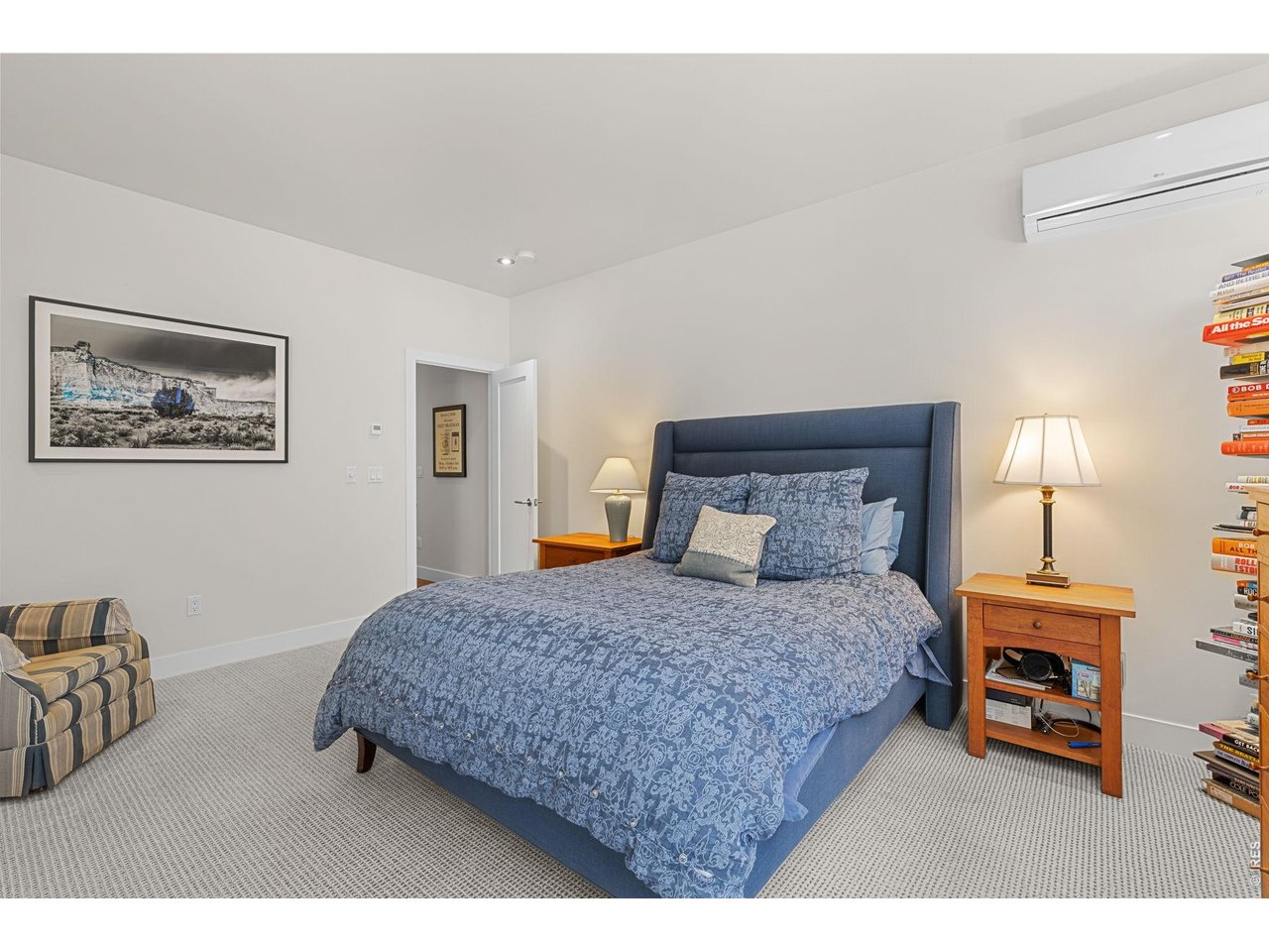 3123 3rd Street Boulder, CO 80304 - Photo 25 of 50 a bedroom with a bed a lamp and a large mirror
