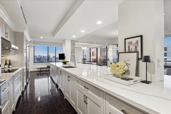a kitchen with a sink dishwasher and a stove with wooden floor