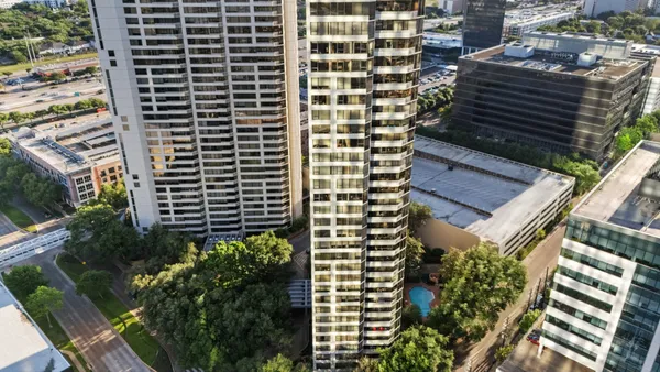 a view of a swimming pool with a patio and a yard