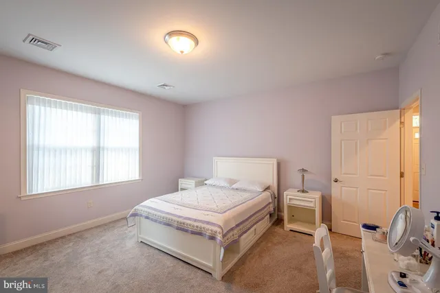 a bed room with a bed and a window