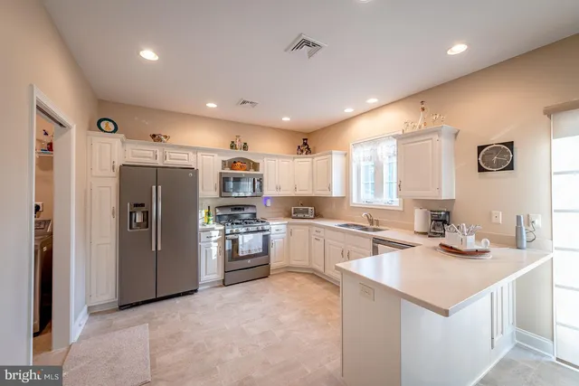 a kitchen with refrigerator and cabinets