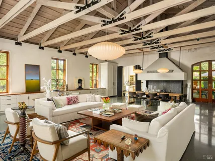 a living room with furniture and a floor to ceiling window