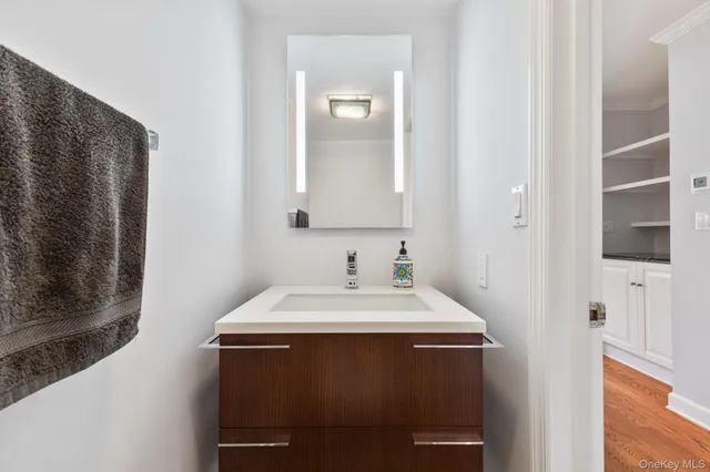 a bathroom with a sink a mirror and a vanity