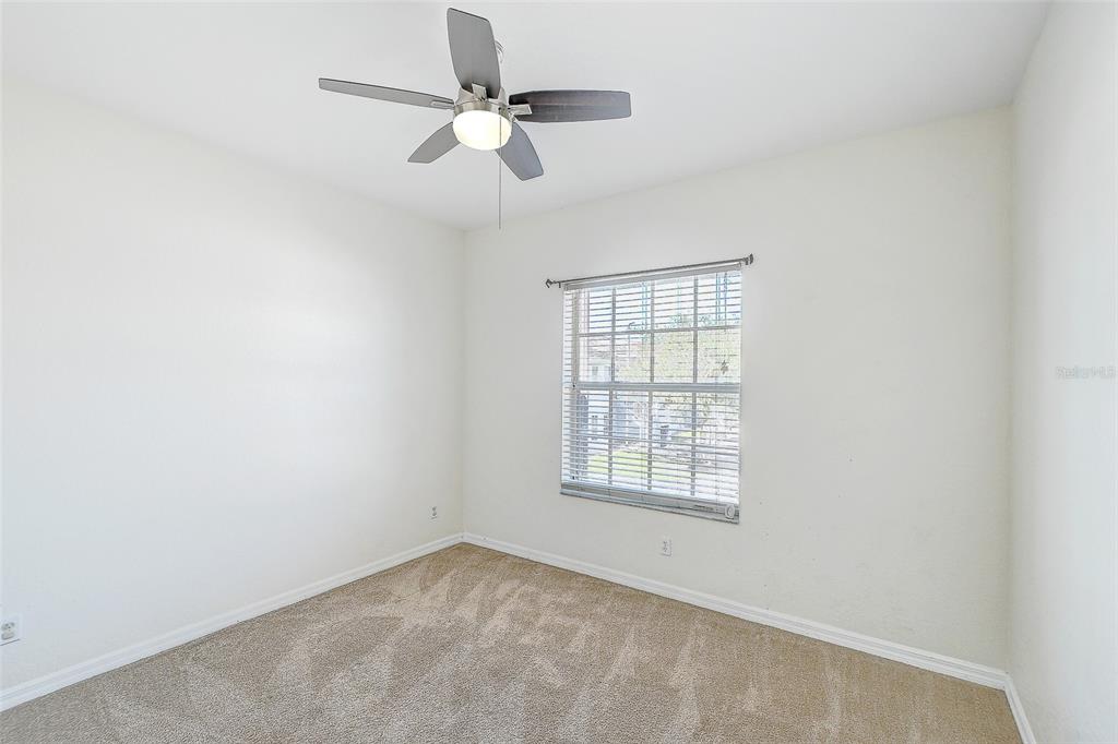 8358 Bernwood Cove Loop, Unit 708 Fort Myers, FL 33966 - Photo 22 of 32 an empty room with a window and a fan