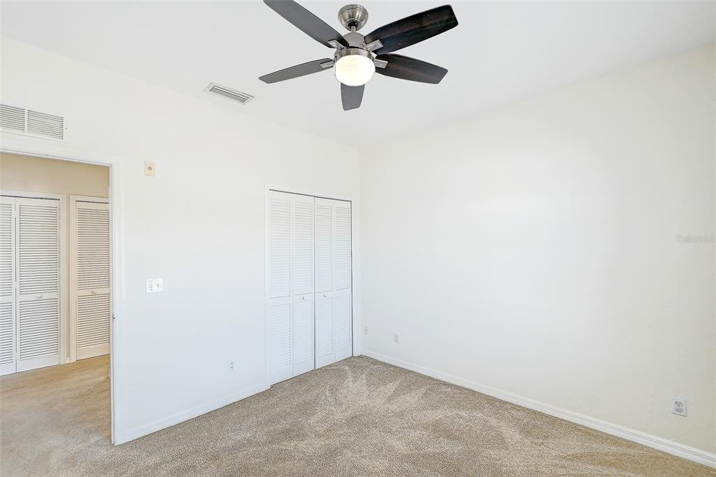 8358 Bernwood Cove Loop, Unit 708 Fort Myers, FL 33966 - Photo 23 of 32 an empty room with a ceiling fan and a window