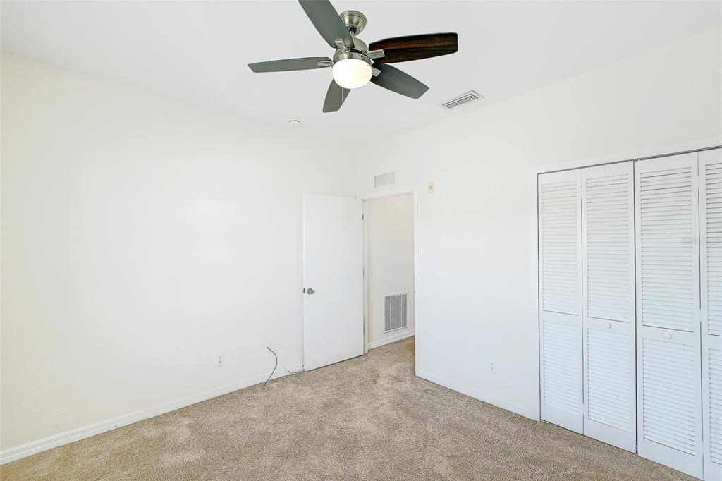 8358 Bernwood Cove Loop, Unit 708 Fort Myers, FL 33966 - Photo 24 of 32 an empty room with ceiling fan