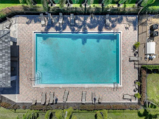 a front view of a house with a yard and potted plants