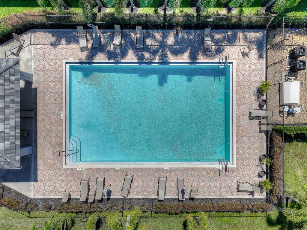 8358 Bernwood Cove Loop, Unit 708 Fort Myers, FL 33966 - Photo 31 of 32 a front view of a house with a yard and potted plants