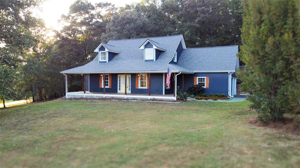 67 Rainbow Circle Cleveland, GA 30528 - Photo 1 of 1 a front view of a house with a garden