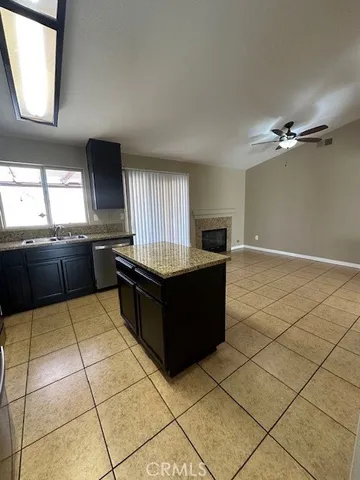 a kitchen with granite countertop a sink and a stove