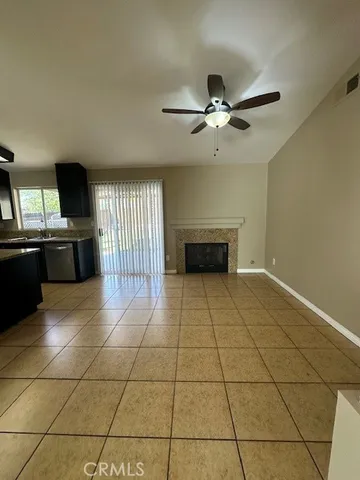 a view of a livingroom with a chandelier fan and windows