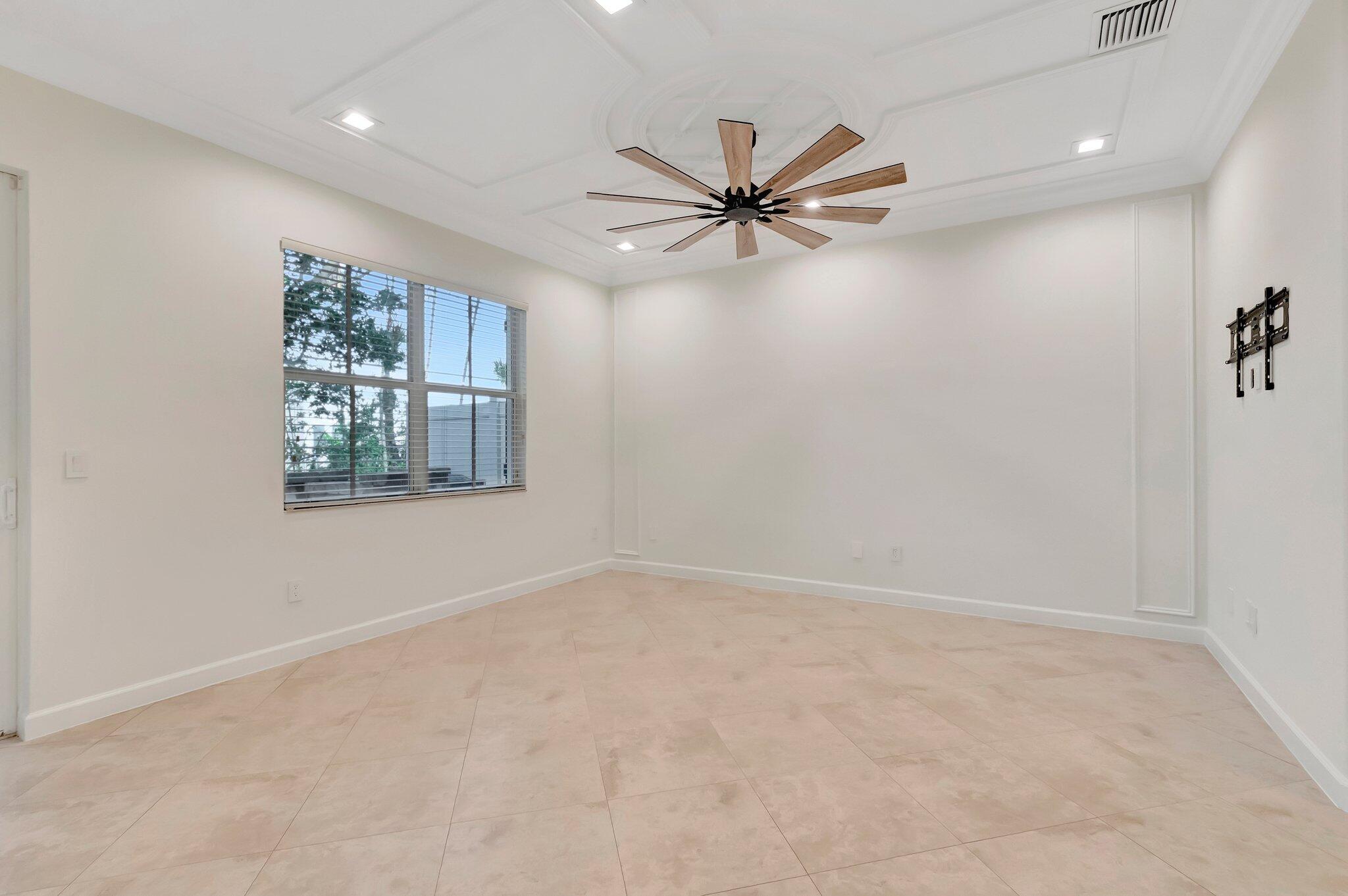 100 West Prive Circle Delray Beach, FL 33445 - Photo 11 of 43 wooden floor in an empty room with a window