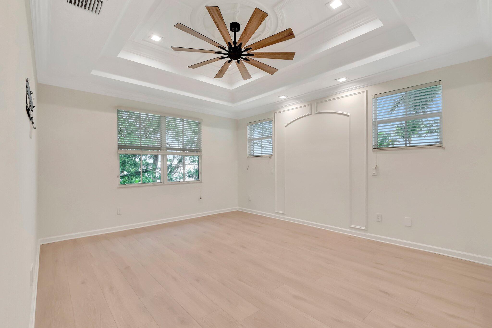 100 West Prive Circle Delray Beach, FL 33445 - Photo 24 of 43 an empty room with windows and ceiling fan