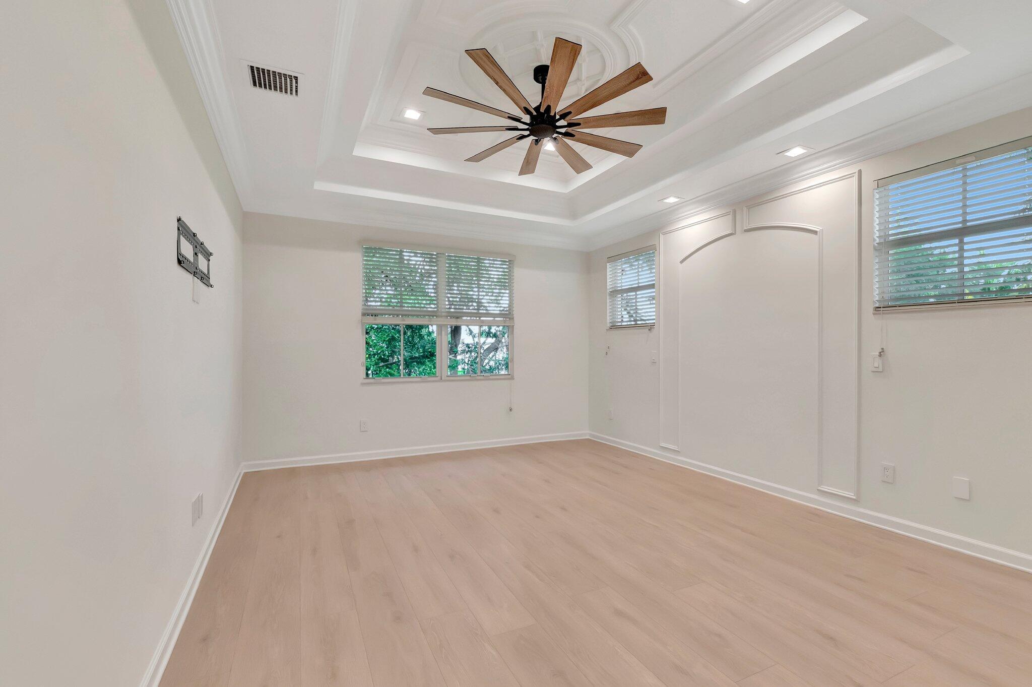 100 West Prive Circle Delray Beach, FL 33445 - Photo 25 of 43 an empty room with windows and ceiling fan
