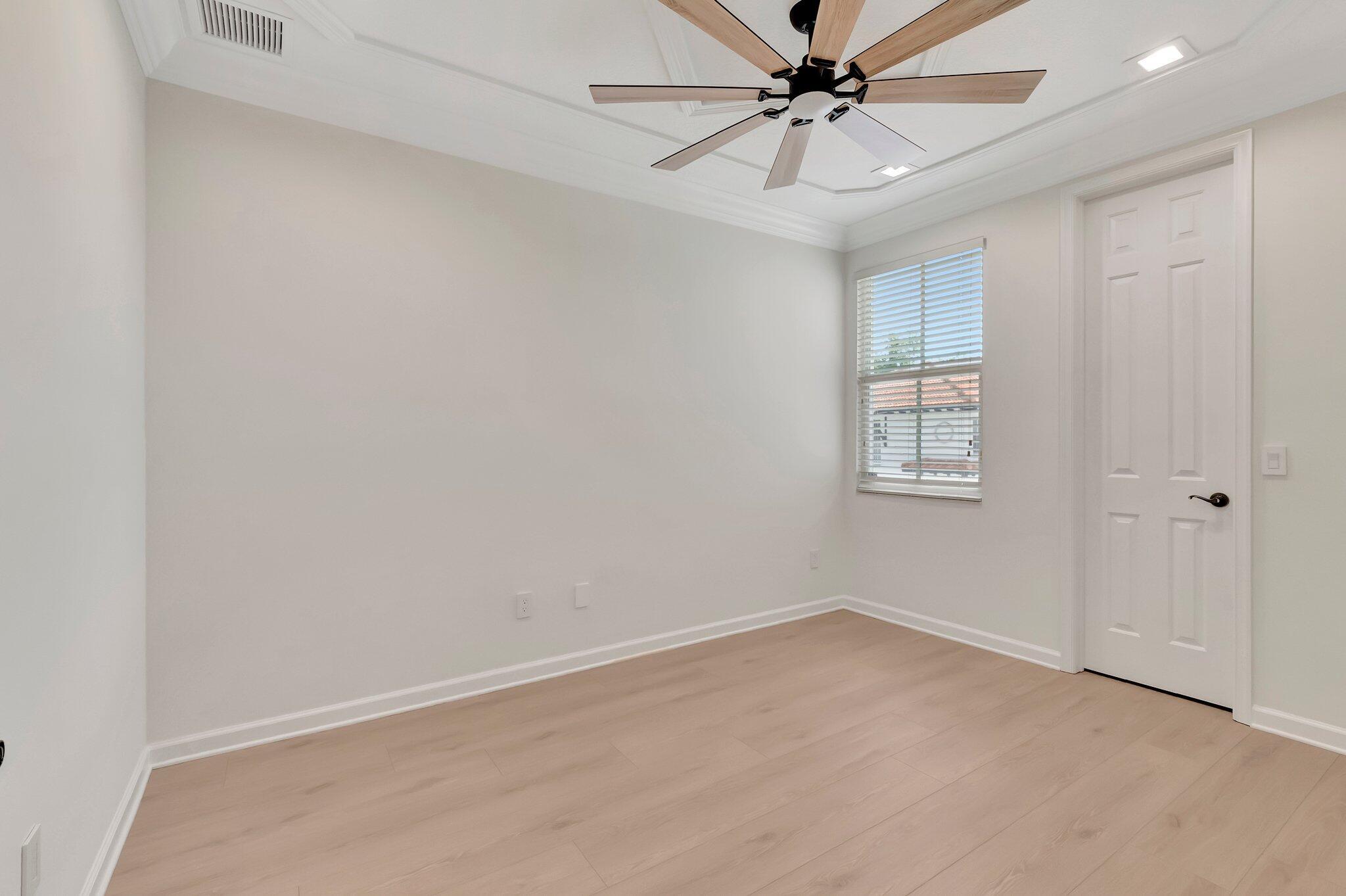 100 West Prive Circle Delray Beach, FL 33445 - Photo 29 of 43 an empty room with windows and fan