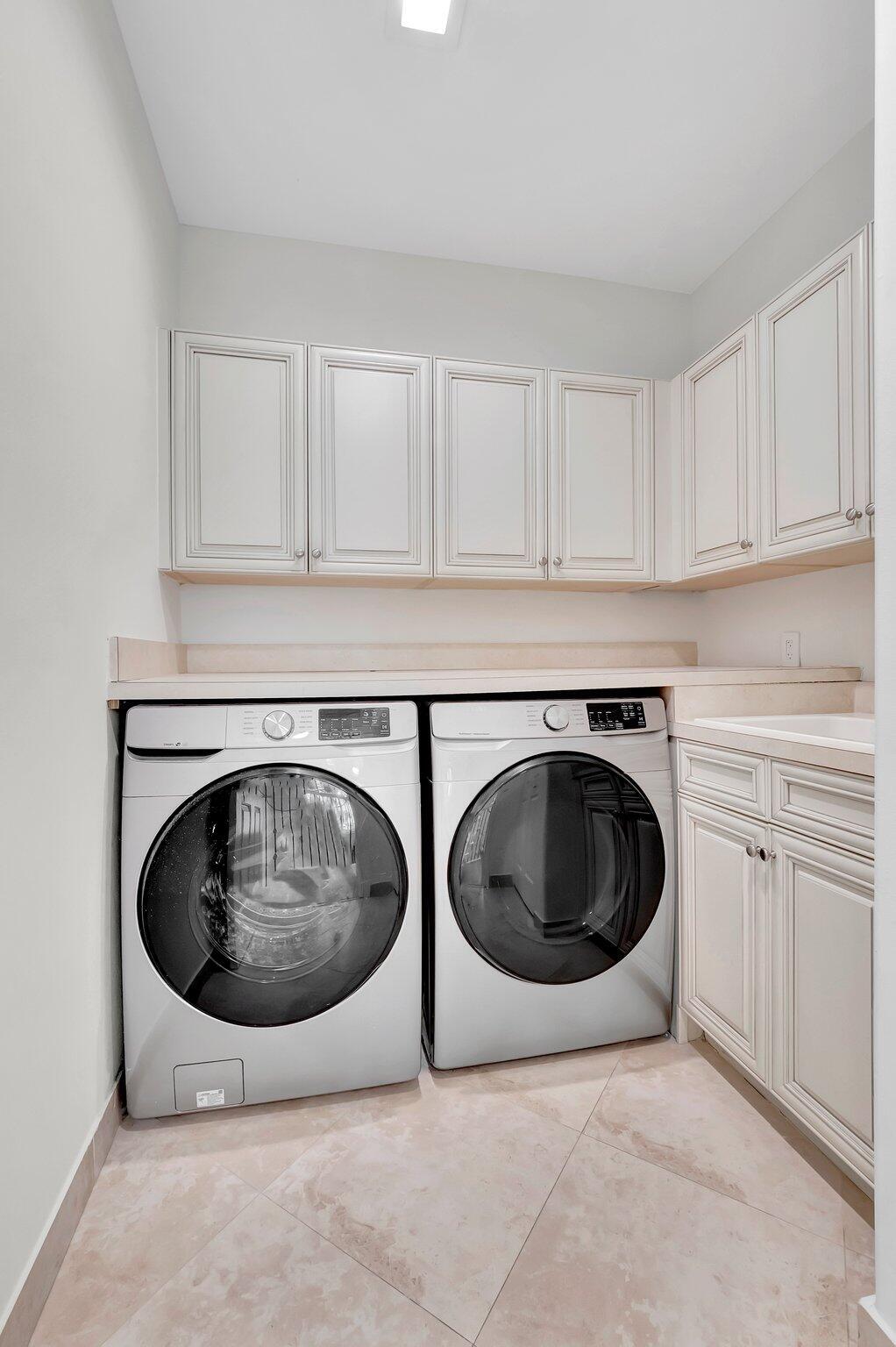 100 West Prive Circle Delray Beach, FL 33445 - Photo 34 of 43 a utility room with sink dryer and washer