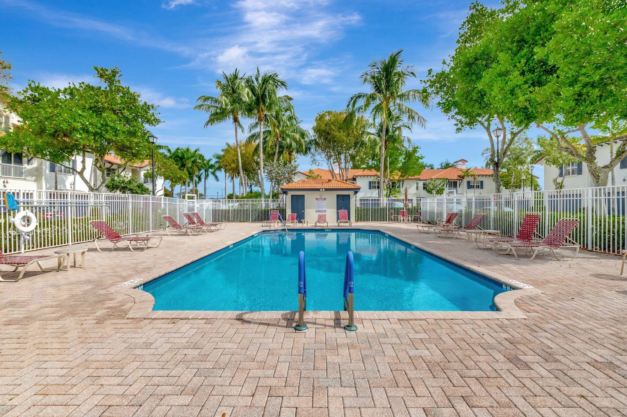 100 West Prive Circle Delray Beach, FL 33445 - Photo 43 of 43 a view of a swimming pool with a patio