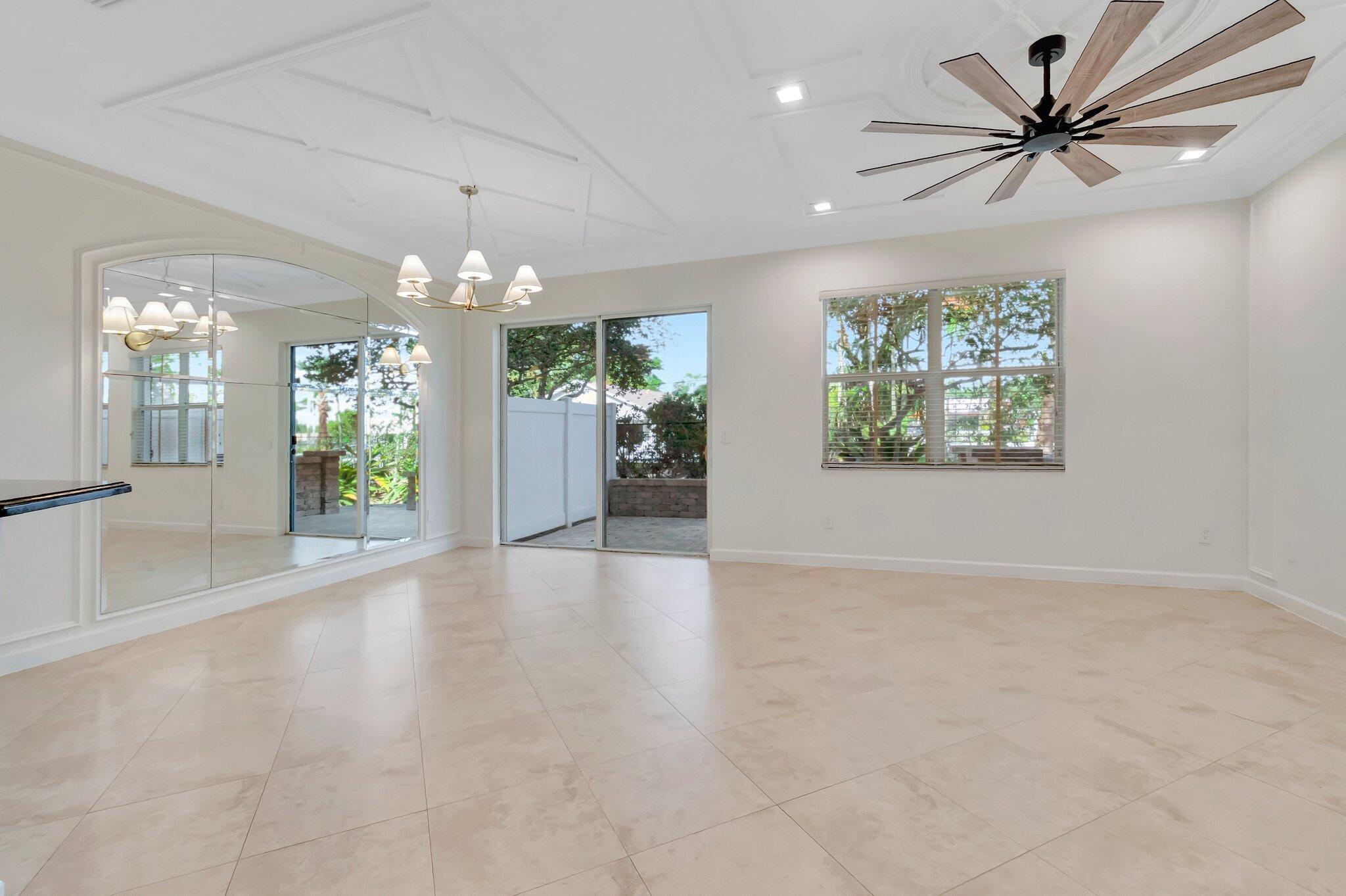 100 West Prive Circle Delray Beach, FL 33445 - Photo 8 of 43 en view interior of a house a chandelier fan and windows