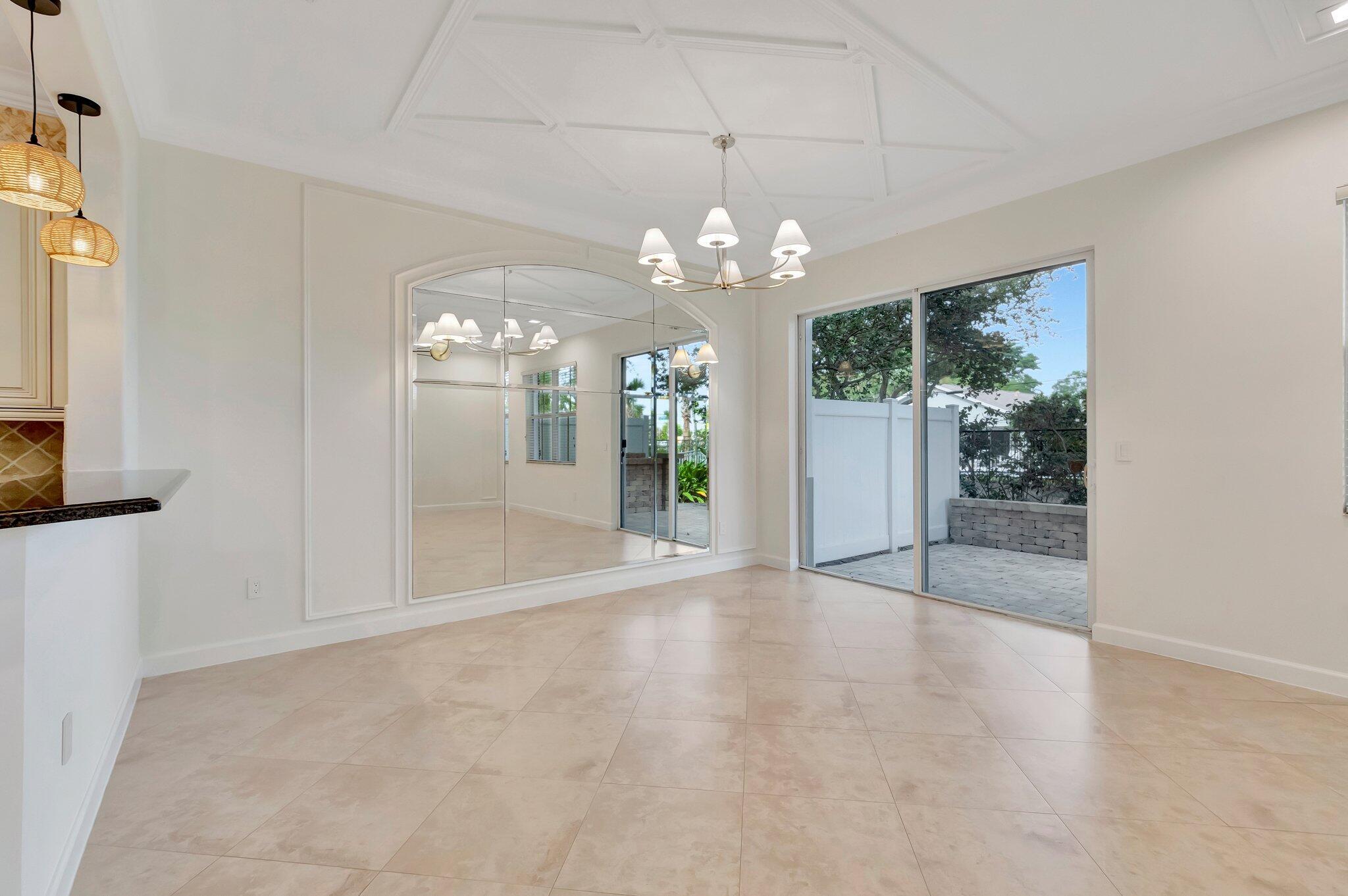 100 West Prive Circle Delray Beach, FL 33445 - Photo 9 of 43 a view of a big room with chandelier fan and windows