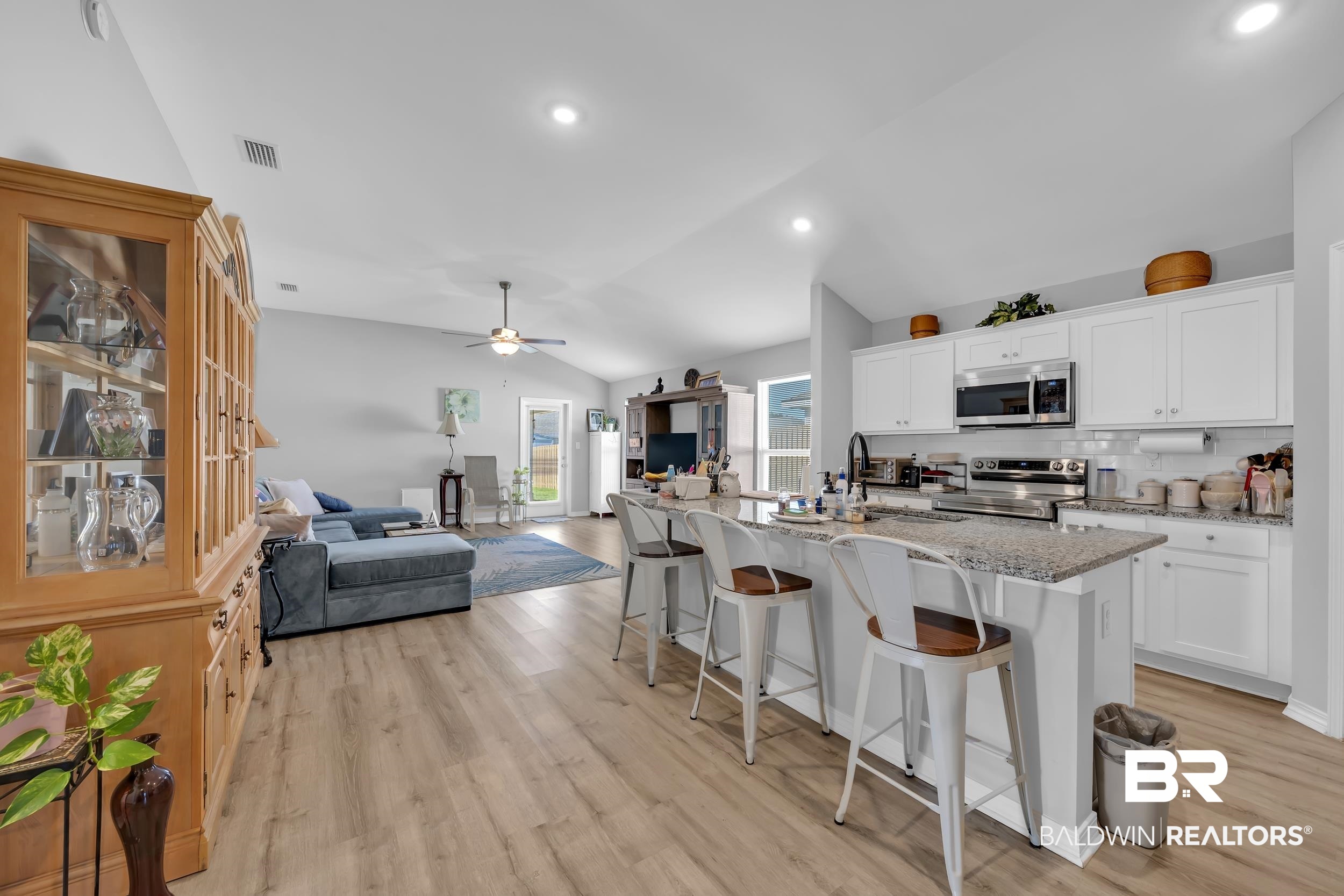 1228 Caper Avenue Foley, AL 36535 - Photo 6 of 54 Open-concept living space featuring wood-finish flooring, recessed lighting, and vaulted ceilings