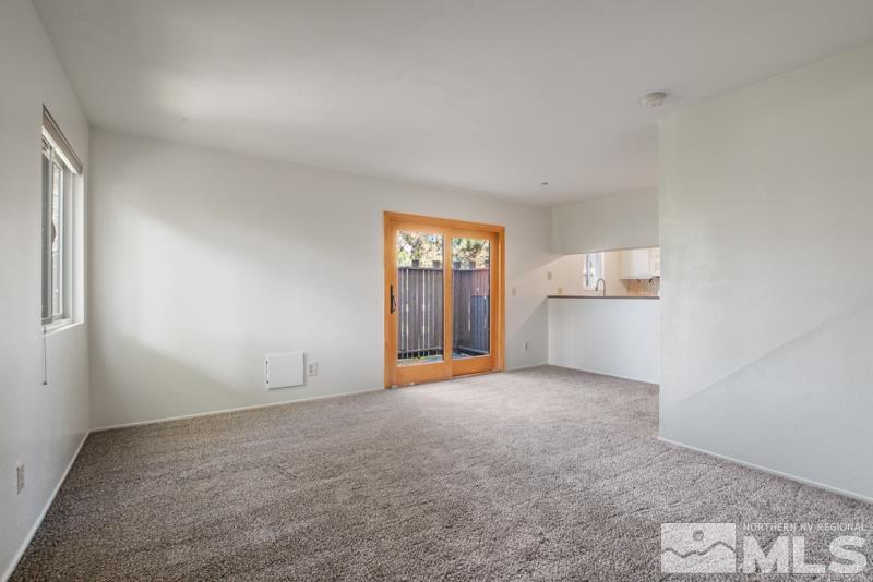 4853 Reggie Road Reno, NV 89502 - Photo 2 of 27 an empty room with windows and cabinet