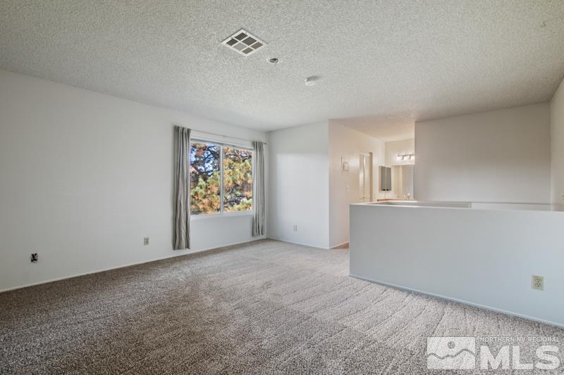 4853 Reggie Road Reno, NV 89502 - Photo 8 of 27 an empty room with windows