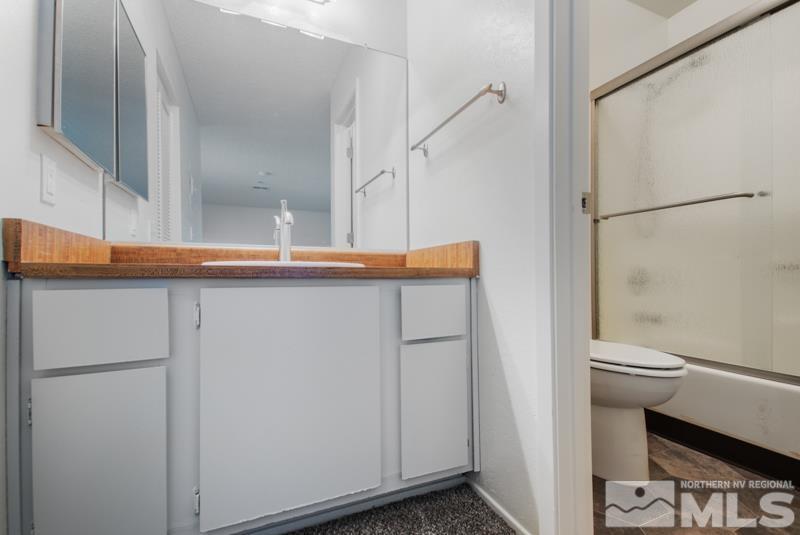4853 Reggie Road Reno, NV 89502 - Photo 10 of 27 a bathroom with a sink and a mirror
